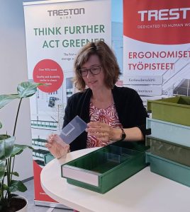 Treston's Marketing Director Minna Lyyra glancing at a Treston BiOX Shelf Bin